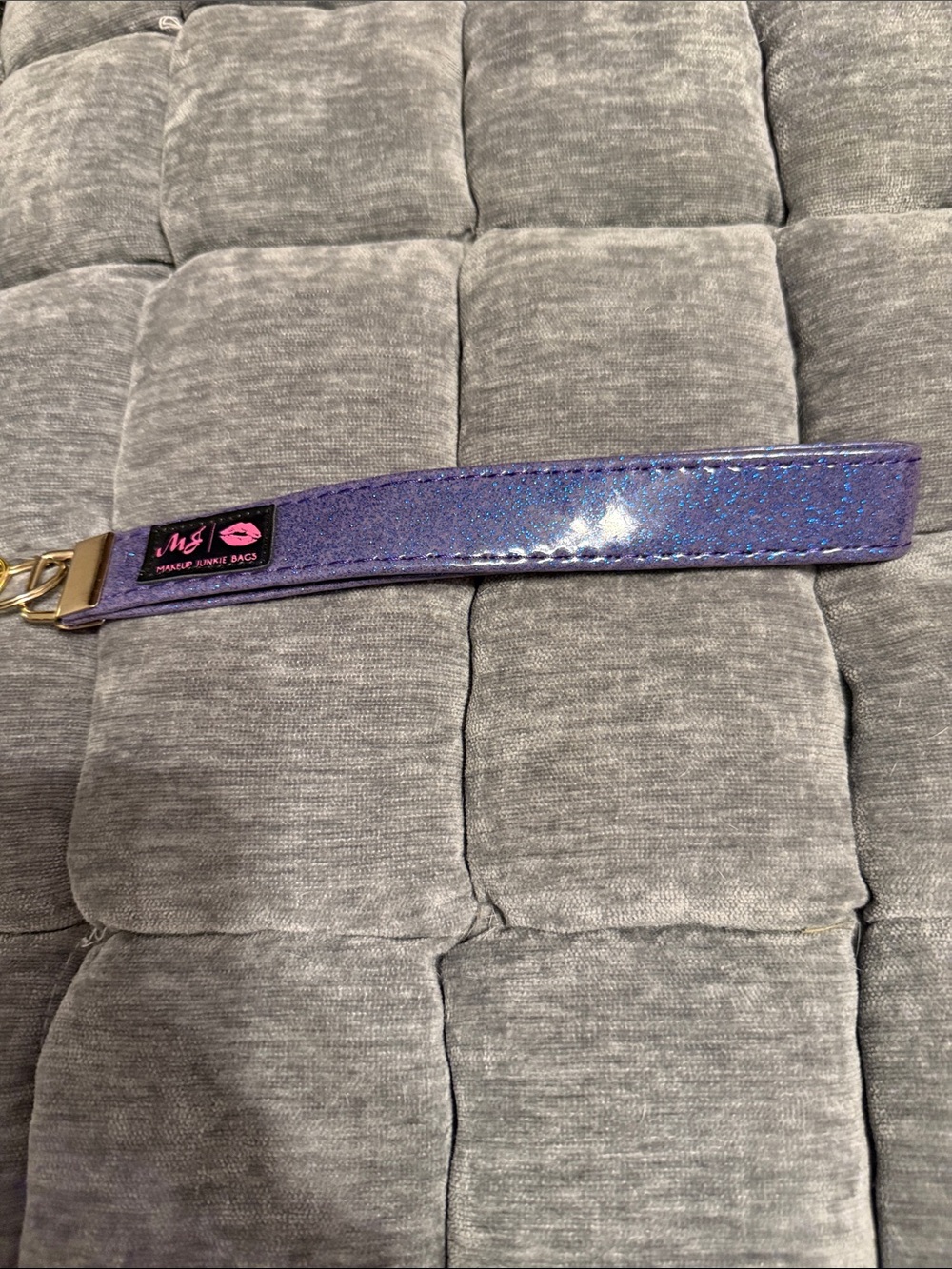 Makeup Junkie purple glitter strap.